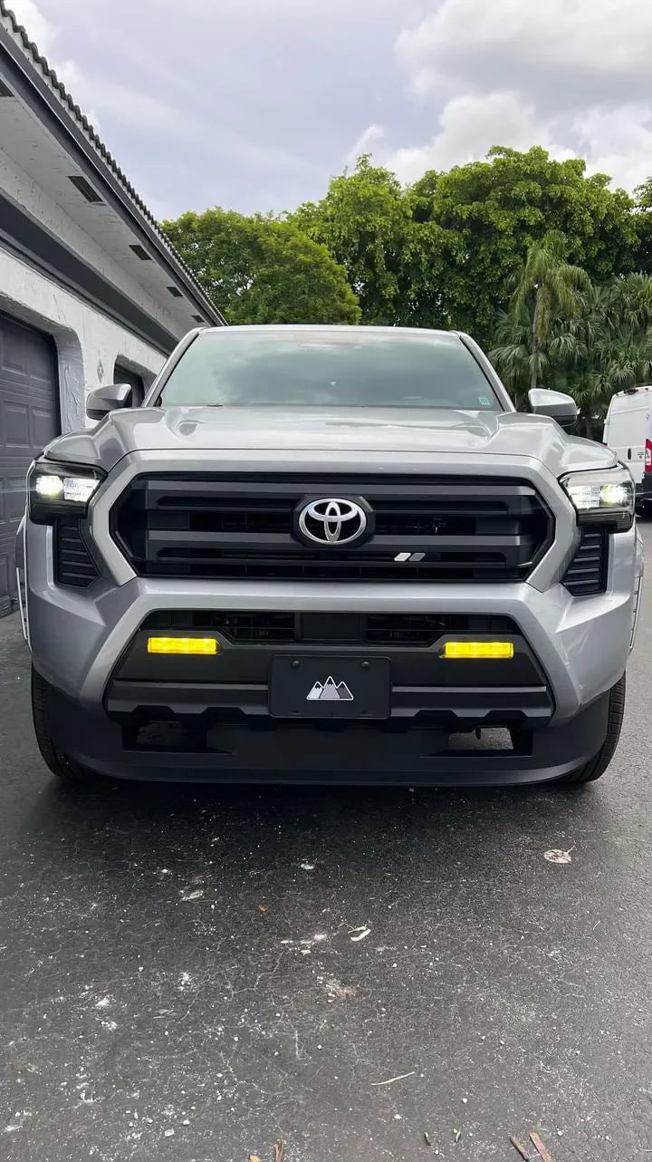 Vinyl fog light overlays for 2024+ Toyota Tacoma, exterior vehicle accessory by StickerFab, shown installed on fog light area.