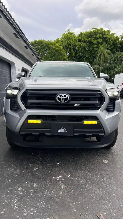 Vinyl fog light overlays for 2024+ Toyota Tacoma, exterior vehicle accessory by StickerFab, shown installed on fog light area.