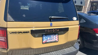 Toyota Land Cruiser 2024+ Topo rear tailgate emblem overlays by StickerFab, close-up of sleek design and branding on vehicle.