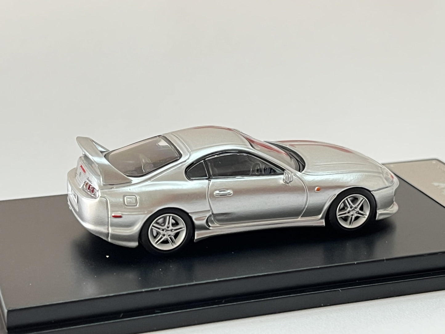 Silver 1:64 scale Toyota Supra JZA80Z diecast model by Lot57Supplies, detailed view showing the sleek design and realistic features.