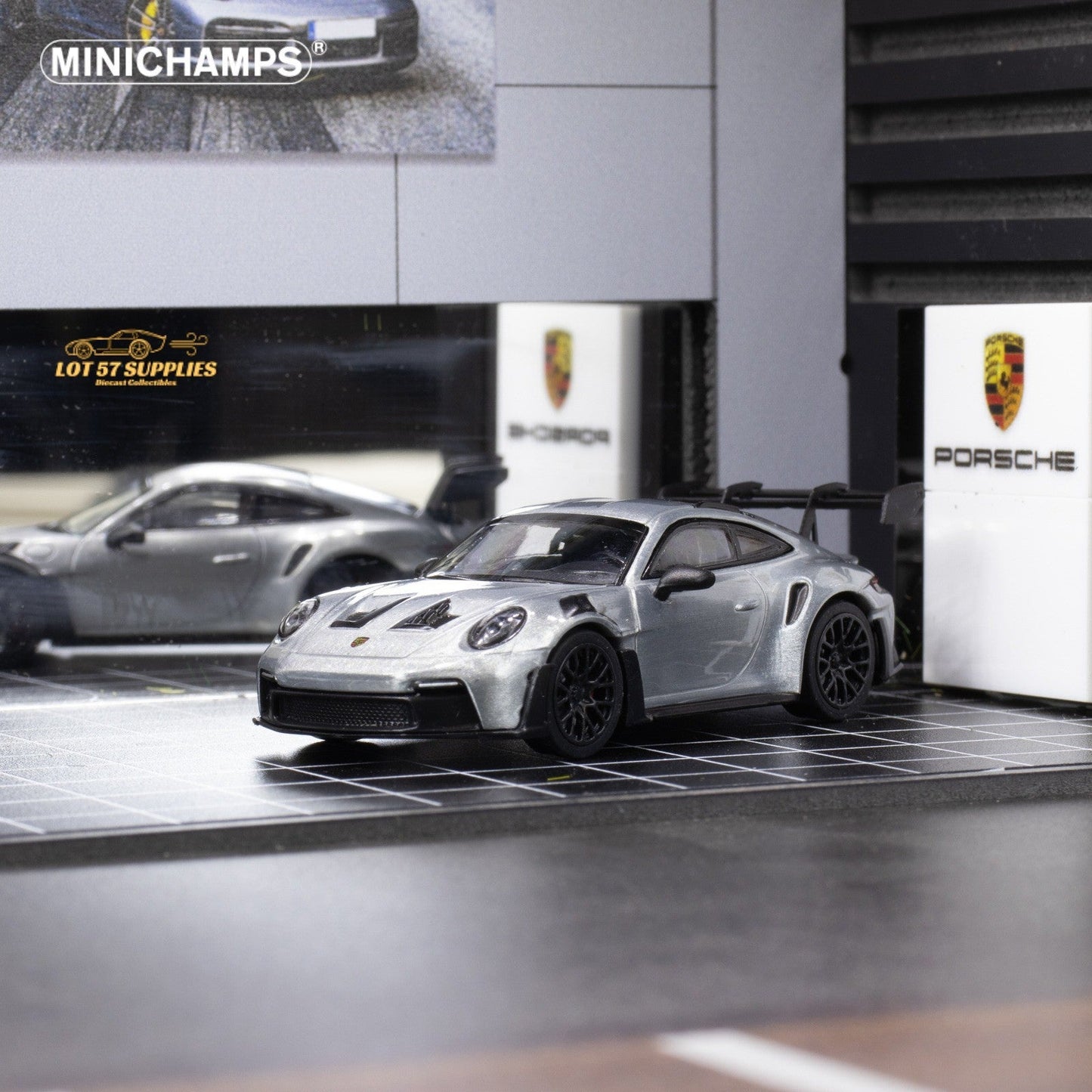 Silver Porsche 911 GT3 RS diecast model in 1:64 scale by Minichamps, featuring detailed exterior and sporty design.