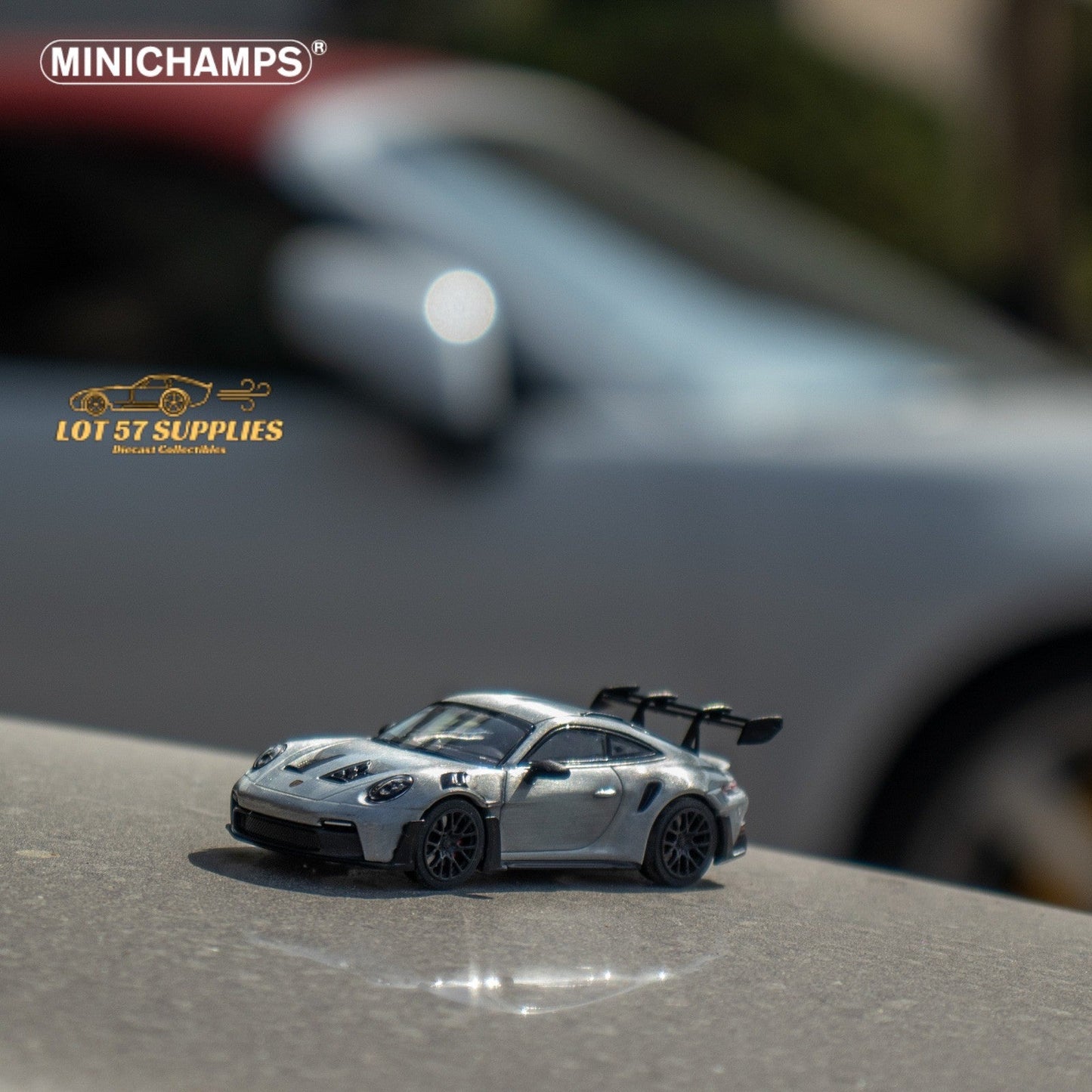 Silver Minichamps Porsche 911 GT3 RS diecast model in 1:64 scale, detailed view showing exterior features and design.