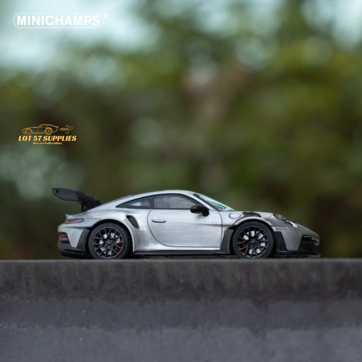 Silver Porsche 911 GT3 RS diecast model in 1:64 scale by Minichamps, shown in a detailed close-up view.