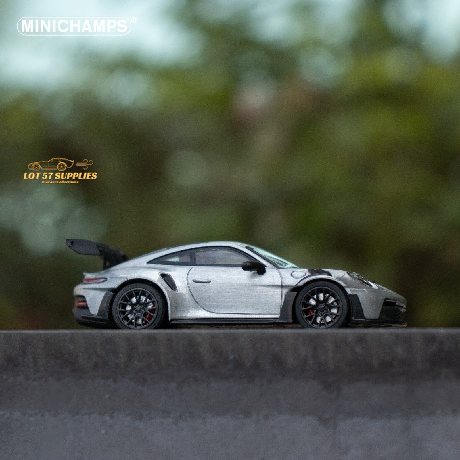 Silver Porsche 911 GT3 RS diecast model in 1:64 scale by Minichamps, shown in a detailed close-up view.