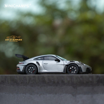 Silver Porsche 911 GT3 RS diecast model in 1:64 scale by Minichamps, shown in a detailed close-up view.