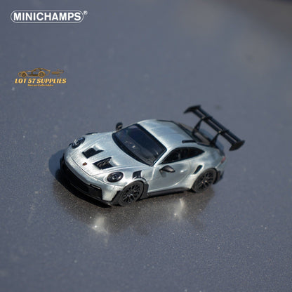 Silver diecast Porsche 911 GT3 RS model car in 1:64 scale by Minichamps, detailed miniature sports car for collectors.
