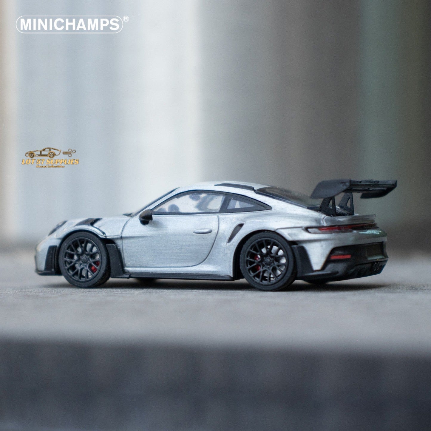 Silver Porsche 911 GT3 RS diecast model in 1:64 scale, detailed miniature car by Minichamps with realistic features.