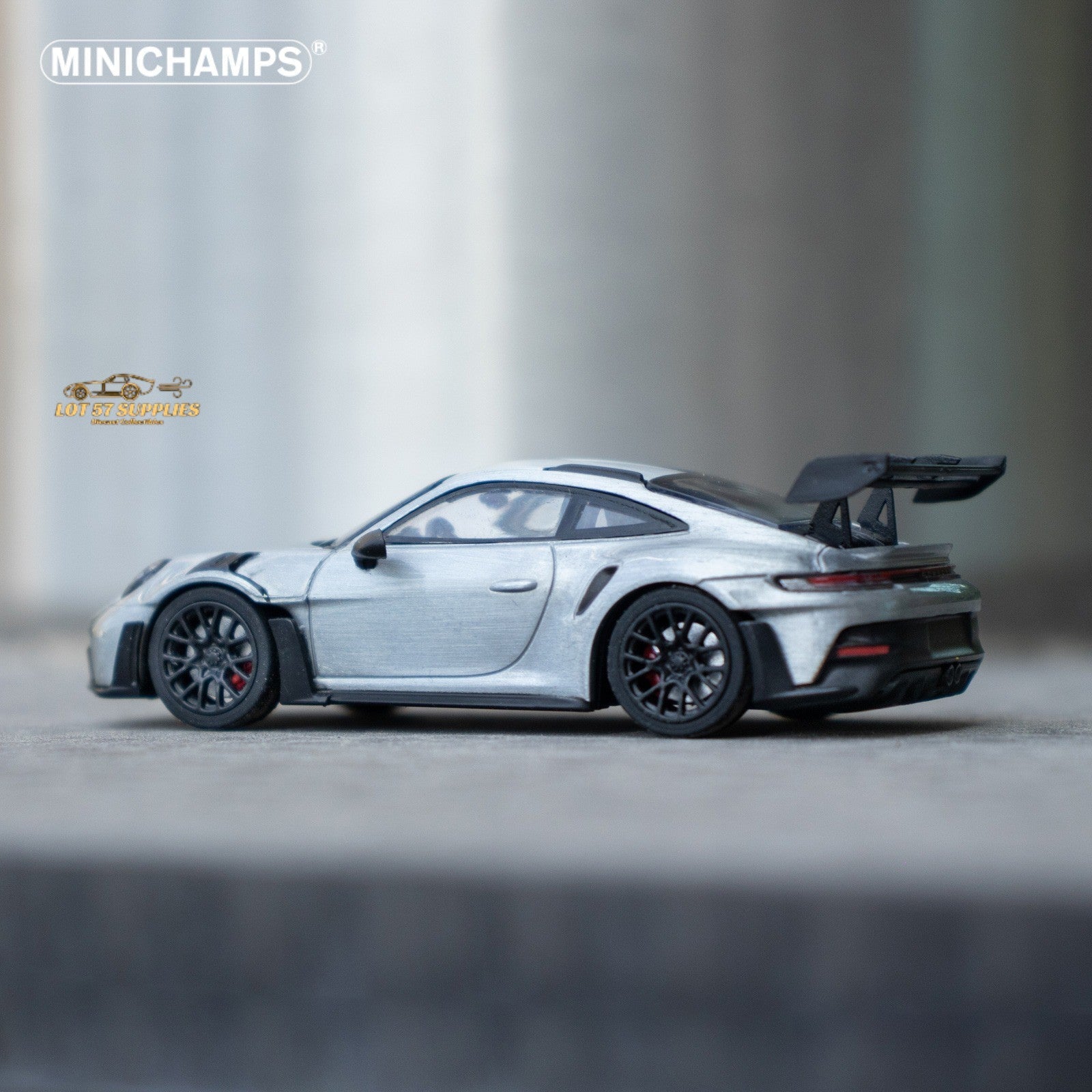 Silver Porsche 911 GT3 RS diecast model in 1:64 scale, detailed miniature car by Minichamps with realistic features.