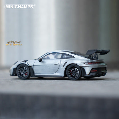 Silver Porsche 911 GT3 RS diecast model in 1:64 scale, detailed miniature car by Minichamps with realistic features.