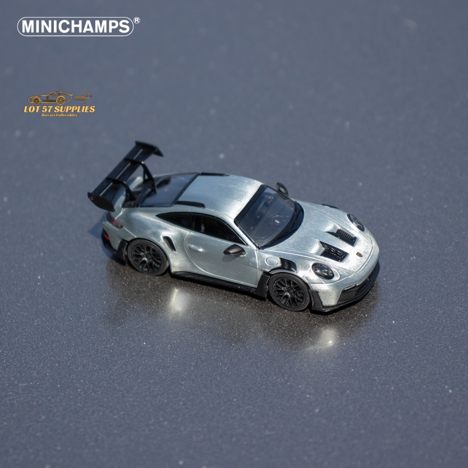 Silver Porsche 911 GT3 RS diecast model by Minichamps, 1:64 scale, showcasing detailed design and realistic features.