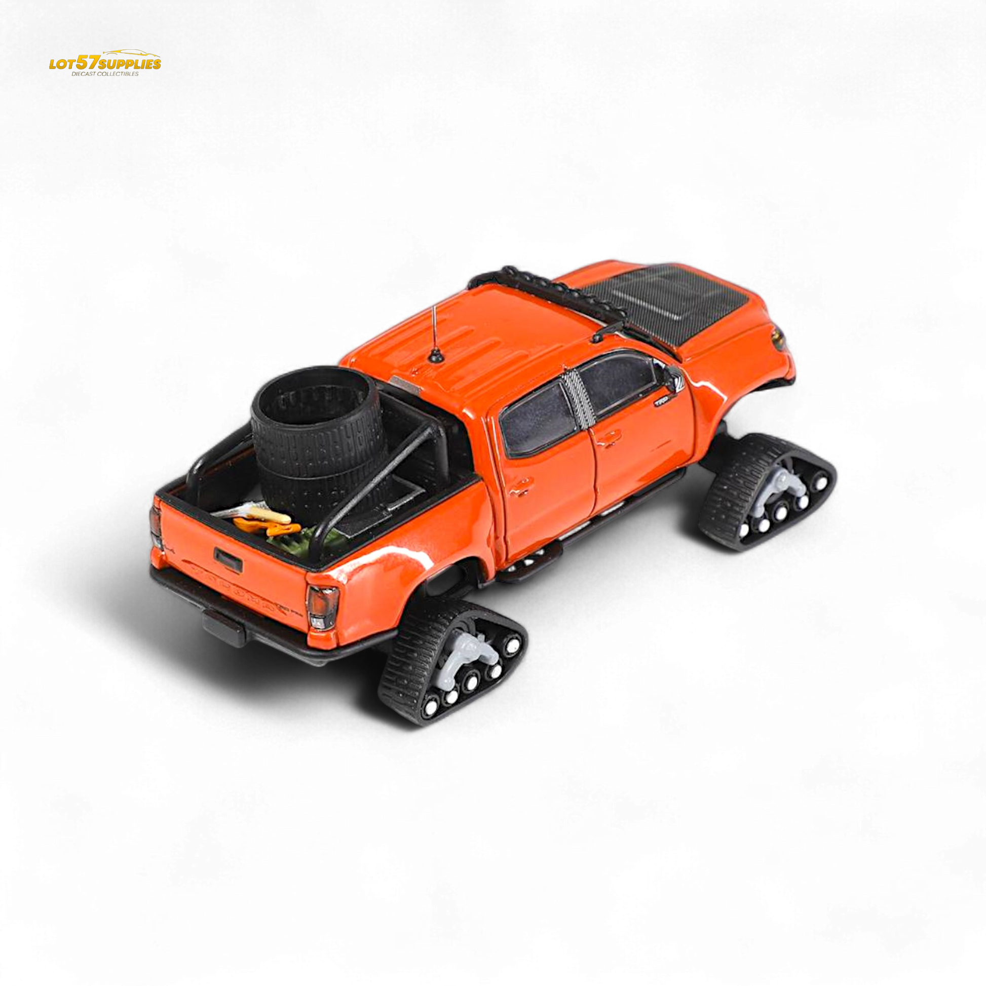Diecast Toyota Tacoma model with orange red GCD 3PMSF tires in 1:64 scale, detailed toy vehicle for collectors.