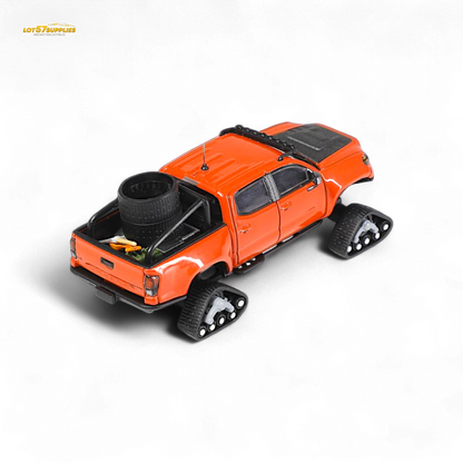 Diecast Toyota Tacoma model with orange red GCD 3PMSF tires in 1:64 scale, detailed toy vehicle for collectors.