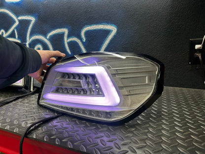 NTXGlow clear RGB color-shifting tail lights for 2015-2021 Subaru WRX/STI, showing illuminated multi-color tail light design.