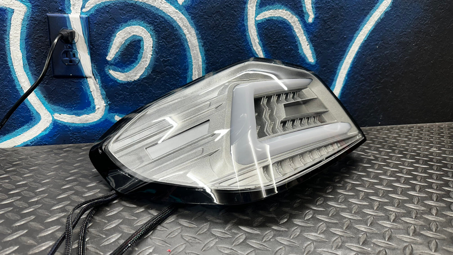 NTXGlow clear RGB color-shifting tail lights for 2015-2021 Subaru WRX and STI, shown installed on a vehicle.