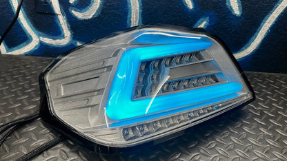NTXGlow clear RGB color-shifting tail lights for 2015-2021 Subaru WRX and STI, shown installed on a car.