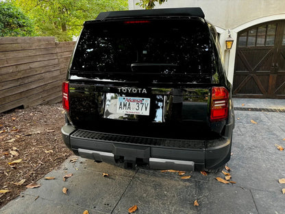 Toyota Land Cruiser 2024+ rear tailgate emblem overlays by StickerFab, sleek metal emblems for authentic vehicle branding.