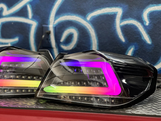 NTXGlow black RGB color-shifting tail lights for 2015-2021 Subaru WRX/STI, showing illuminated lights on a vehicle.