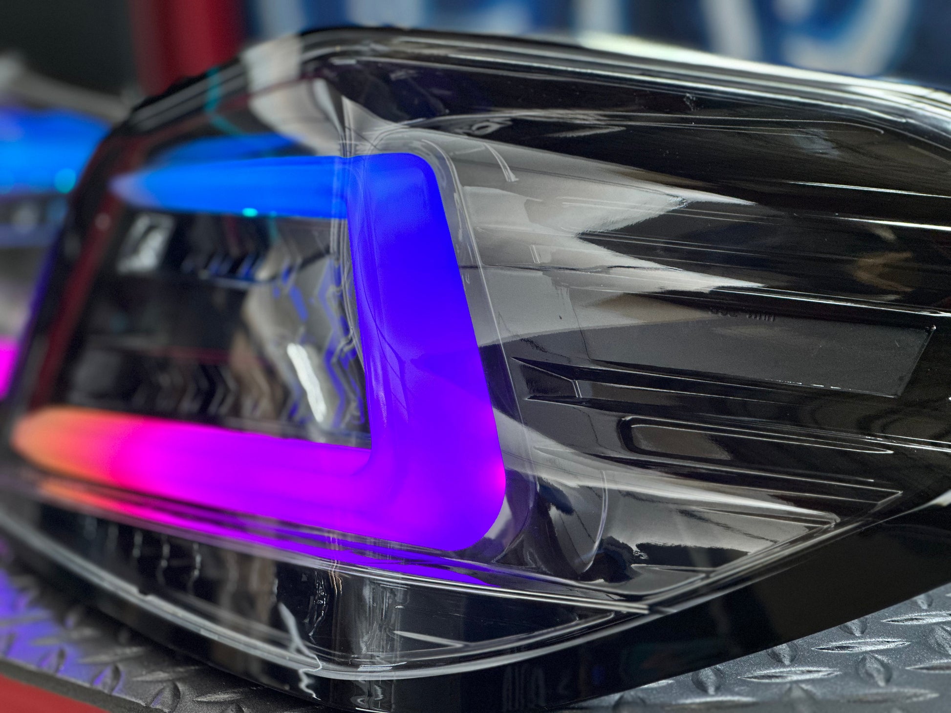 NTXGlow black RGB color-shifting tail lights for 2015-2021 Subaru WRX/STI, shown on a vehicle, featuring modern automotive lighting.