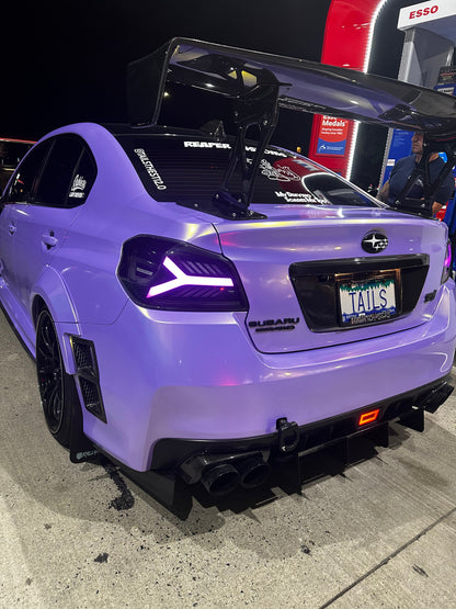 OLM Y-Spec LED taillights for 2015-2021 Subaru WRX/STI with smoke lens and RGB optic lighting, shown on vehicle.