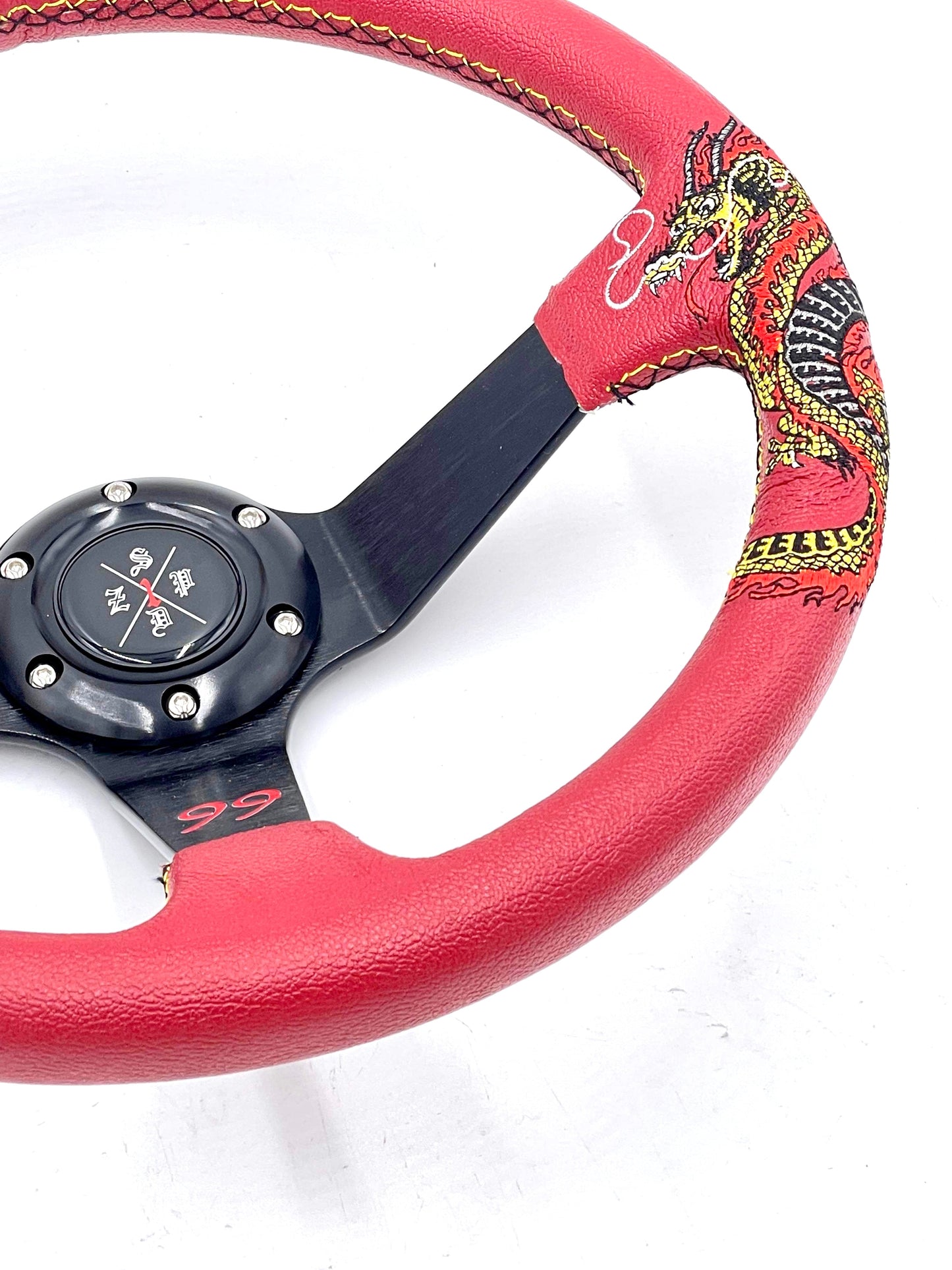 Red SPDZ1 “The Dragon” steering wheel by Speedzone Performance LLC, showcasing its intricate dragon design and premium grip.