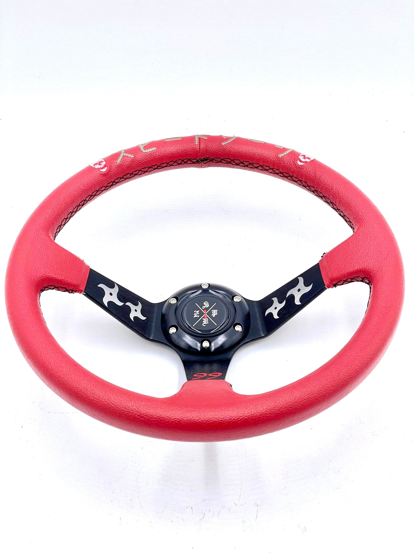 Red SPDZ1 “The Ninja” deep dish steering wheel by Speedzone Performance LLC, showcasing its sleek design and grip details.
