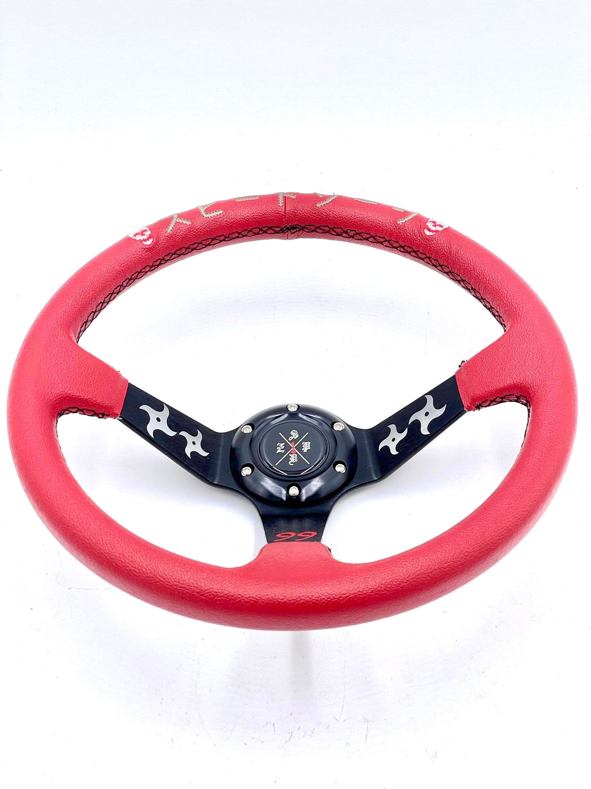 Red SPDZ1 “The Ninja” deep dish steering wheel by Speedzone Performance LLC, showcasing its sleek design and grip details.