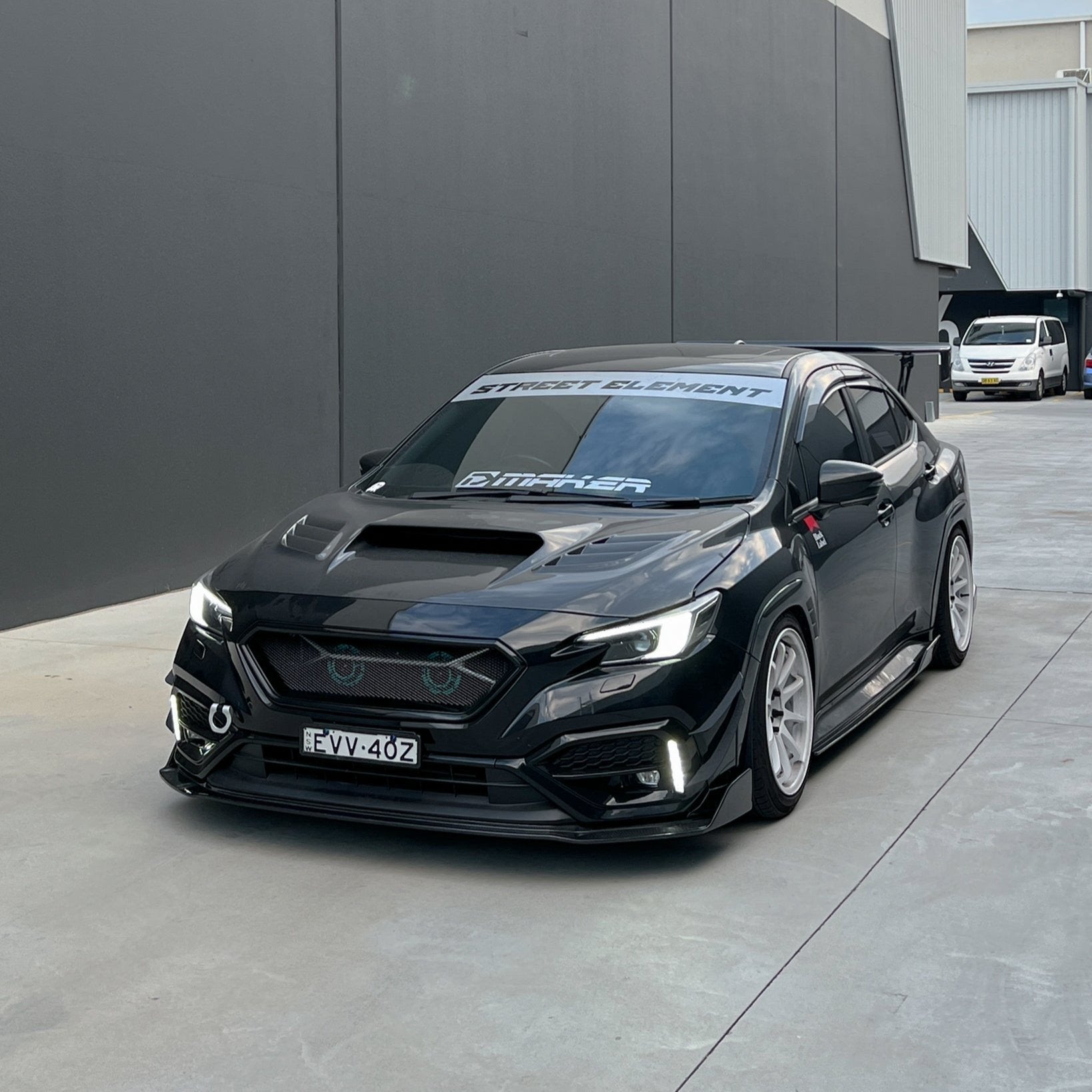 JDMuscle 22-25 WRX CS Style V1 front bumper grille in paint-matched and gloss black finish, showcasing sleek automotive design
