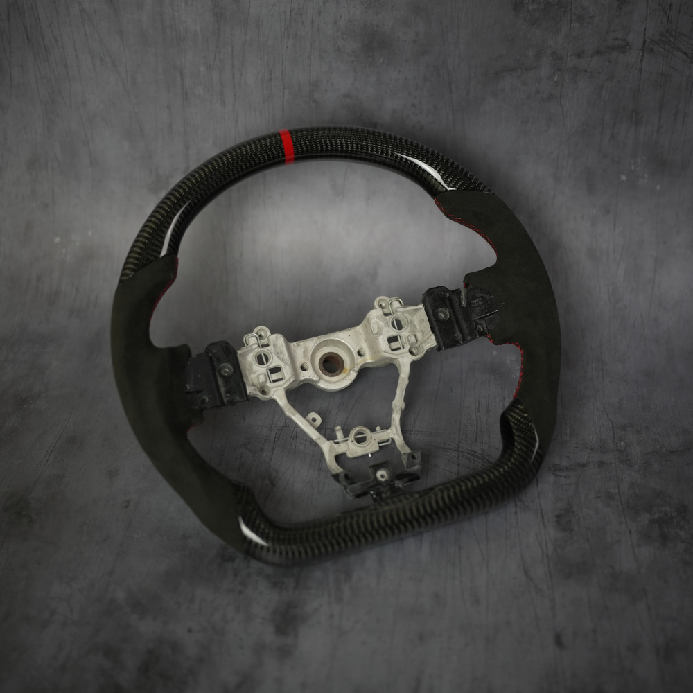 JDMuscle carbon fiber steering wheel for 2015-2021 WRX and STI, showcasing sleek black carbon fiber with ergonomic design.