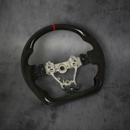 JDMuscle carbon fiber steering wheel for 2015-2021 WRX and STI, showcasing sleek black carbon fiber with ergonomic design.