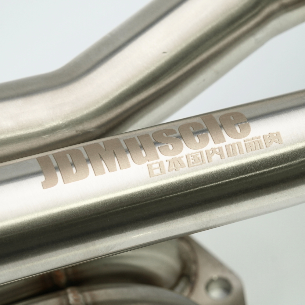 JDMuscle 22-25 WRX unequal length exhaust headers for manual and CVT transmission, showing polished metal manifold with engine connections.