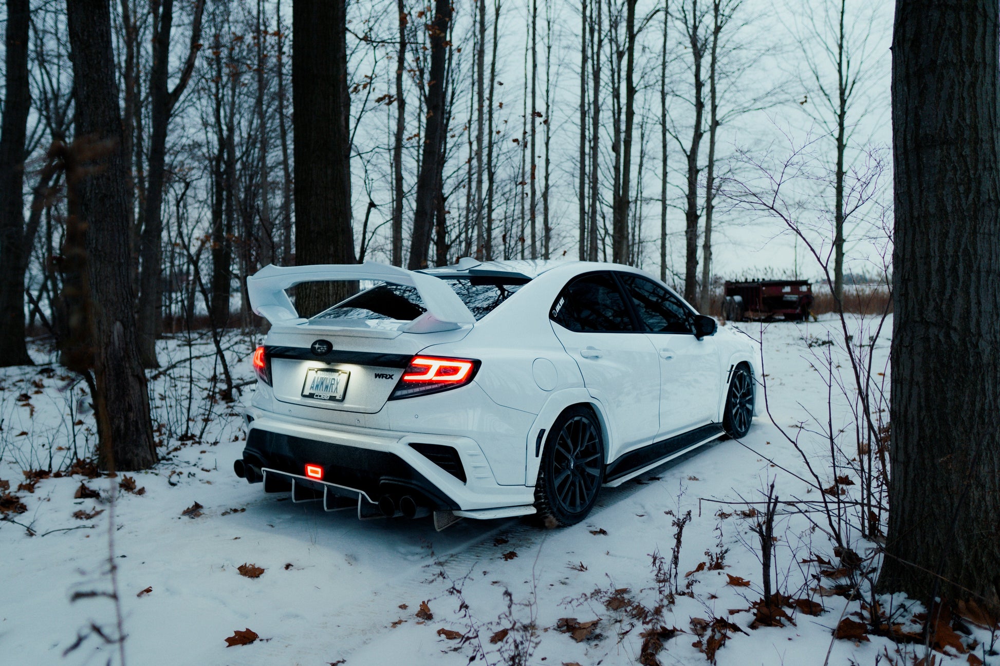 OLM Spec-AR LED taillights with clear lens, black base, and white bar on a 2022+ Subaru WRX, showing the tail light design.