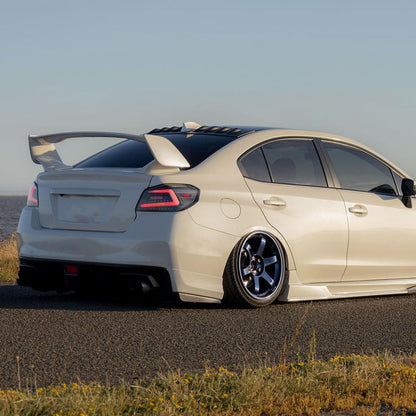 NTXGlow Spec-D LED tail lights with black housing for 2015-2021 Subaru WRX and STI, featuring sleek red and clear lenses.