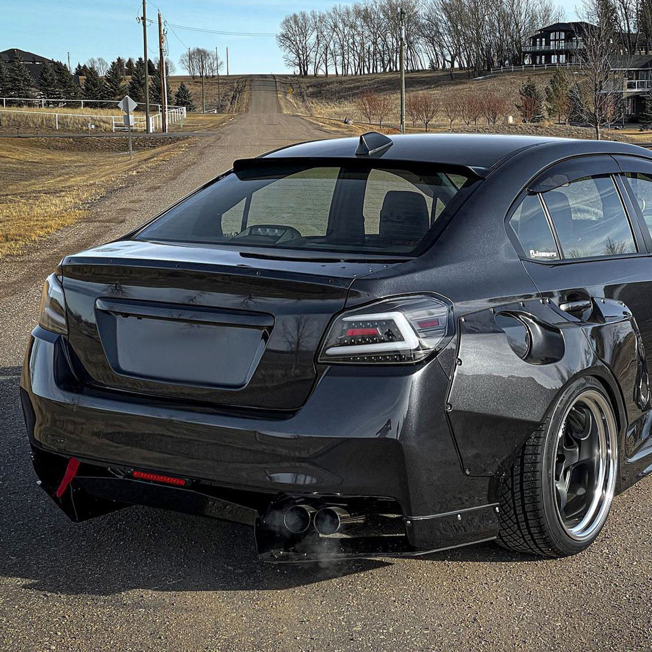 Black housing NTXGlow Spec-D LED tail lights for 2015-2021 Subaru WRX and STI, featuring sleek design and bright illumination.