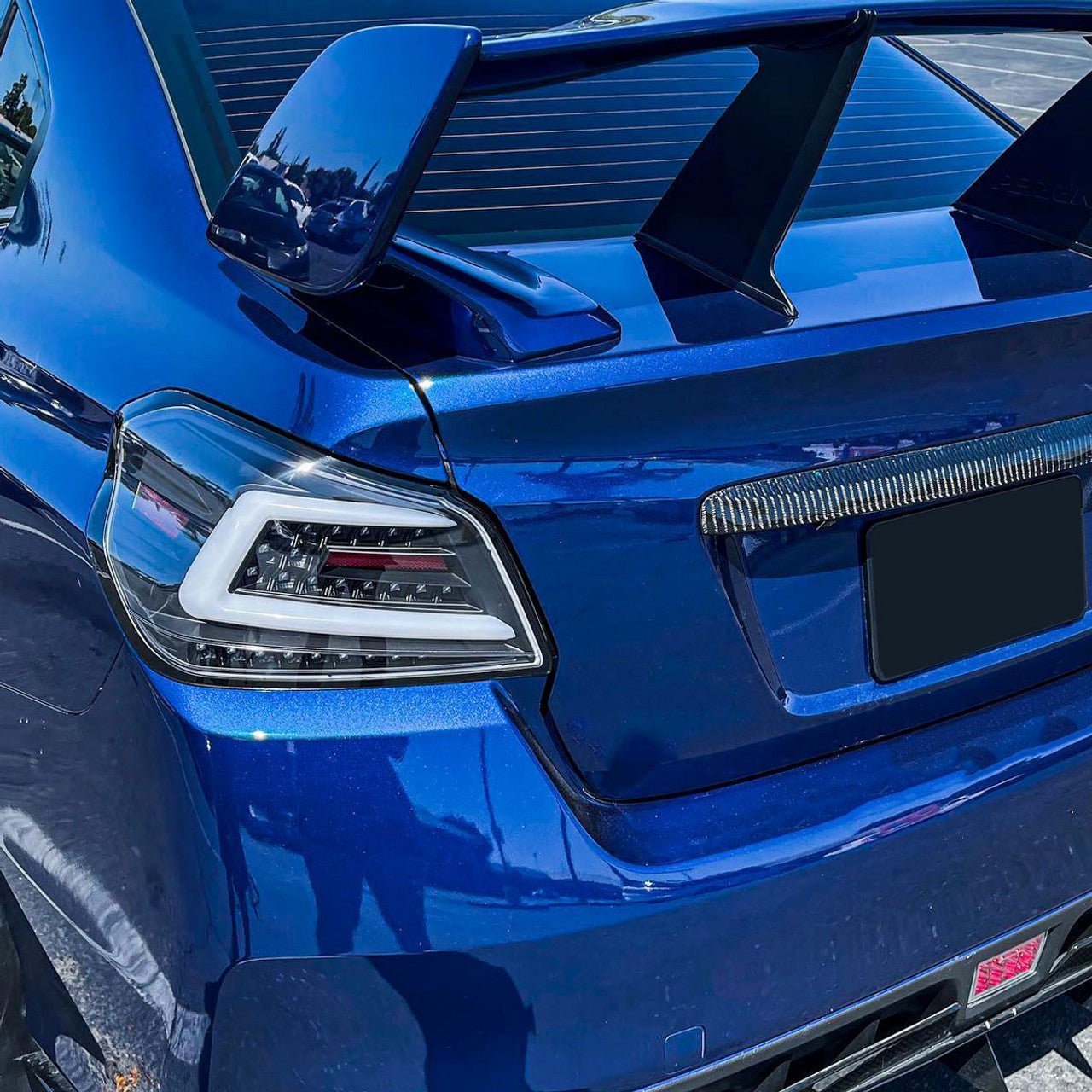 NTXGlow Spec-D LED tail lights in black housing for 2015-2021 Subaru WRX and STI, featuring bright red and clear lenses.