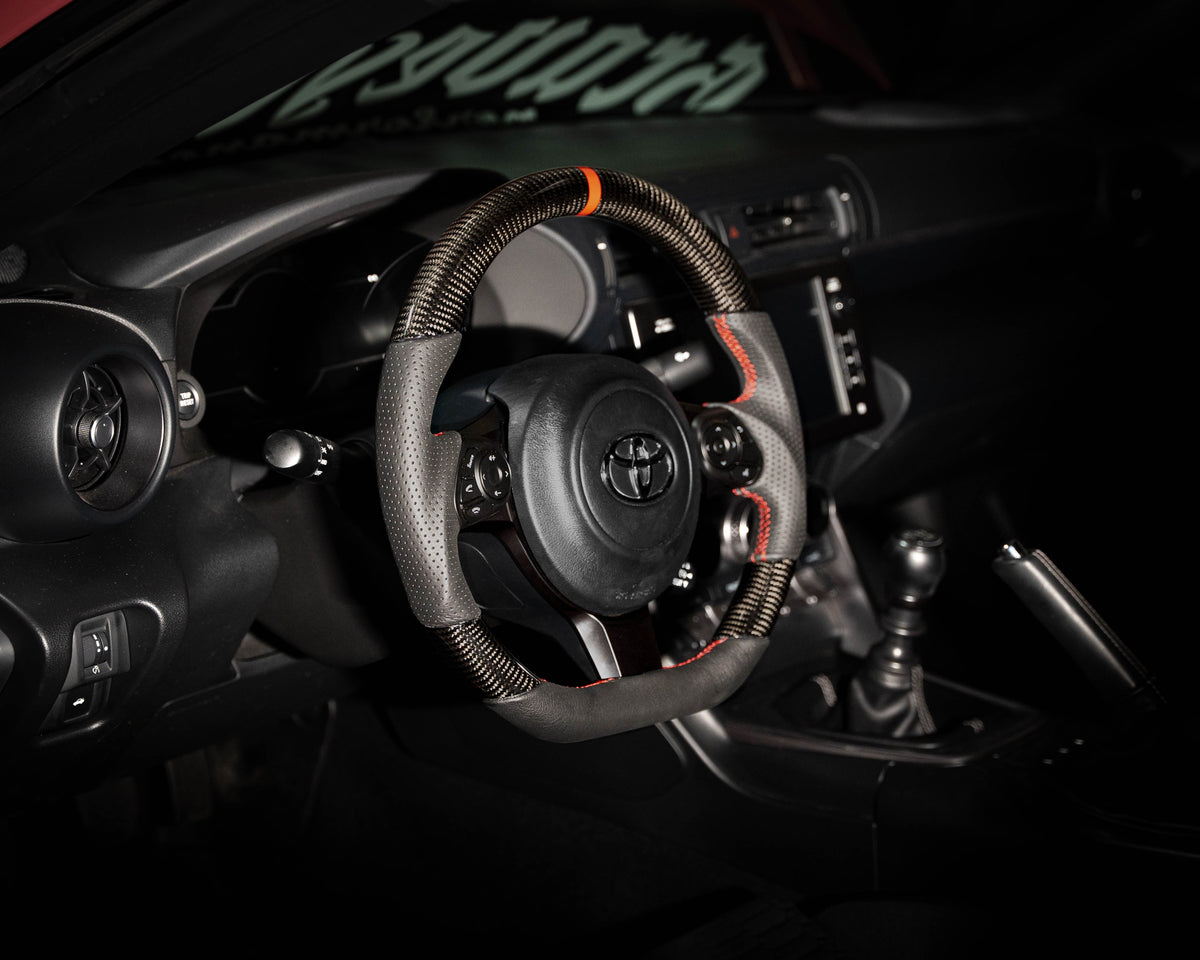 FactionFab carbon and leather steering wheel for 2017+ Subaru BRZ and Toyota 86, showcasing sleek design and premium materials.