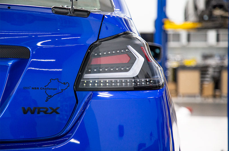 OLM Evolution tail lights for 2015-2021 Subaru WRX/STI, clear lens, black base, white bar, automotive tail light assembly