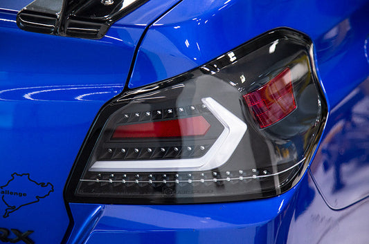 OLM Evolution tail lights for 2015-2021 Subaru WRX STI, clear lens, black base, white bar, automotive rear lighting.