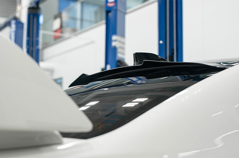 OLM V2 Rear Window Visor for 2015-2021 Subaru WRX and STI, shown installed on the vehicle's rear window.