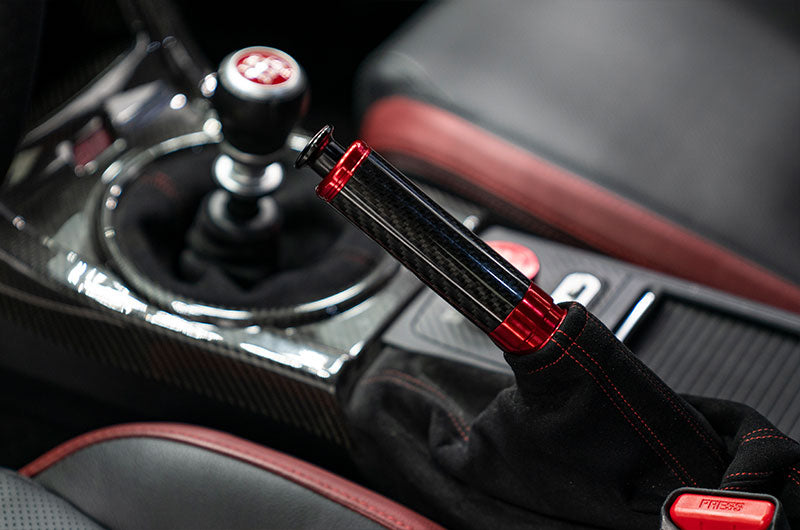 OLM Signature Series red and black carbon e-brake handle for Subaru BRZ, WRX, and STI