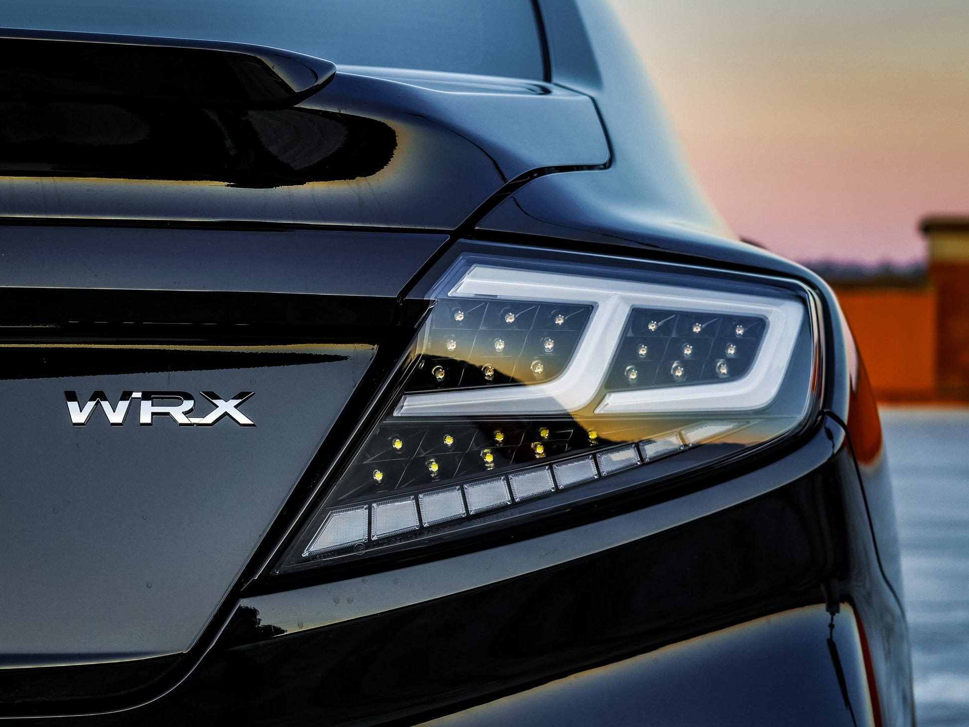 OLM Spec-AR LED taillights for 2022+ Subaru WRX with clear lens, black base, and white bar, showing the sleek tail light design