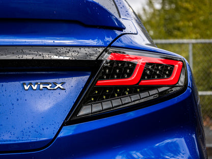 OLM Spec-AR LED taillights for 2022+ Subaru WRX, clear lens with black base and red bar, shown on a vehicle.
