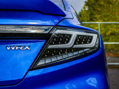 OLM Spec-AR LED taillights with clear lens, black base, and white bar installed on a 2022+ Subaru WRX.