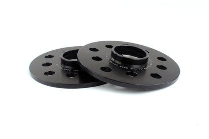 Black PERRIN 7mm wheel spacers for Subaru WRX, STI, Outback, Legacy, and Forester, shown on a vehicle wheel.