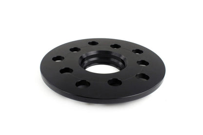 JDMuscle black 7mm wheel spacers for Subaru WRX, STI, Outback, Legacy, and Forester, shown installed on vehicle wheels.
