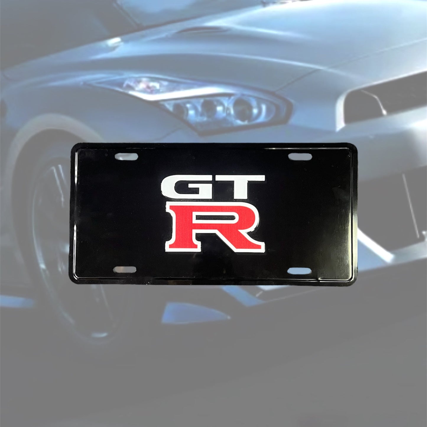 Illumaesthetic GTR dealer license plate with bold lettering on a black background, designed for automotive customization.