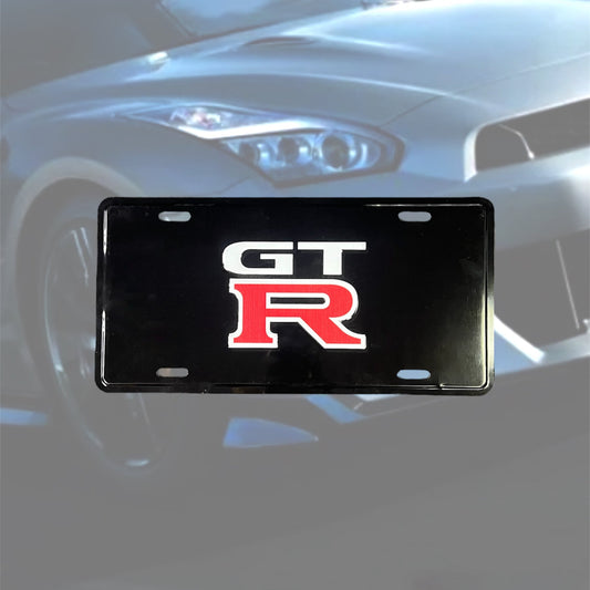 Illumaesthetic GTR dealer license plate with bold lettering on a black background, designed for automotive customization.