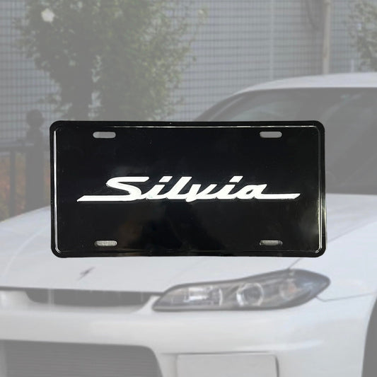 Illumaesthetic Silvia Dealer Plates license plate with sleek design, displayed on a clean background.