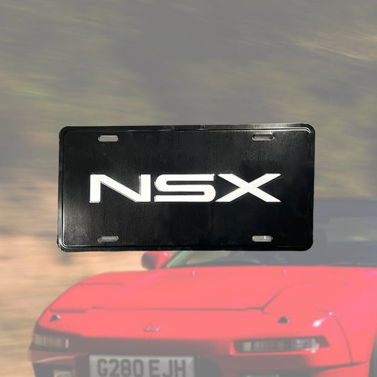 Illumaesthetic NSX dealer license plate with black lettering on a white background, designed for vehicle identification.