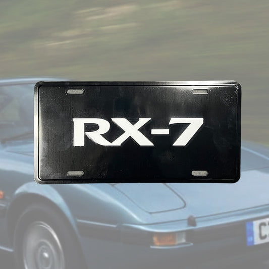 Illumaesthetic RX7 dealer license plate featuring a sleek design on a standard metal plate, ideal for vehicle identification.