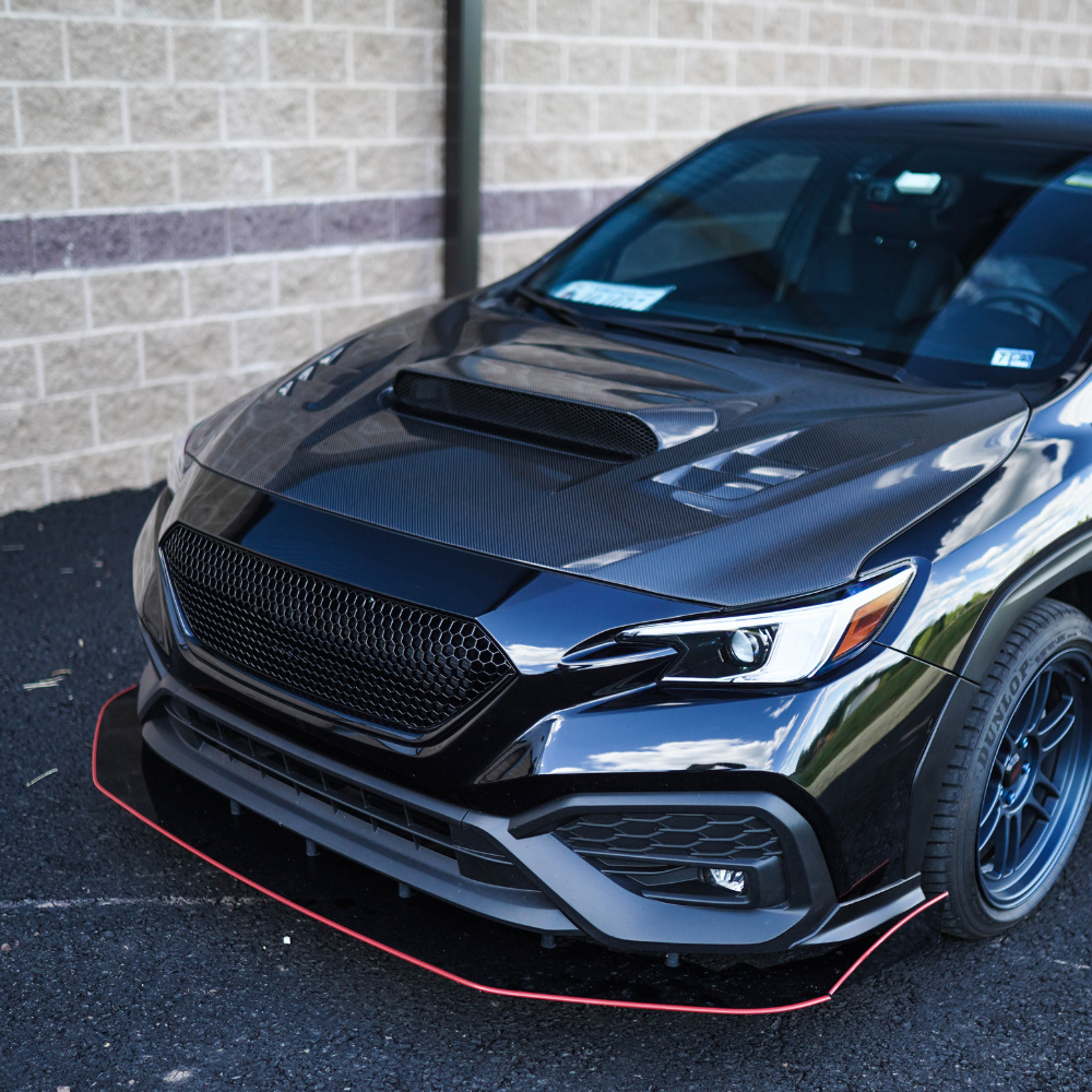 JDMuscle 22-25 WRX sport grille showing sleek black design with cutouts for airflow and a bold front-end appearance.